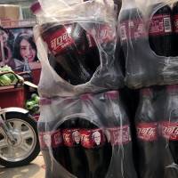 Bottles of Cherry Coca-Cola with portraits of Berkshire Hathaway Chairman and CEO Warren Buffett are stacked near a dispatch rider’s bike in Beijing Tuesday. China on Monday promised retaliation if U.S. President Donald Trump escalates their tariff battle, raising the risk Beijing might target operations of American companies as it runs out of imports for penalties. China stalls on licenses for U.S. financial companies amid Trump tariff battle
