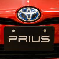 The Toyota Motor Corp. badge is displayed on a Prius hybrid vehicle. The Japanese auto giant has recalled more than 1 million hybrid cars globally due to a technical problem that could cause a fire. Toyota recalls 1 million hybrid cars over technical problem that could lead to fire