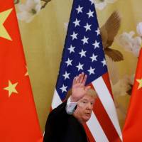 U.S. President Donald Trump waves while making joint statements with China’s President Xi Jinping at the Great Hall of the People in Beijing in November 2017. As U.S. readies to slap more tariffs on China, no end in sight for trade tensions