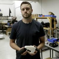 Cody Wilson holds a 3D-printed gun called the Liberator at his shop in Austin, Texas, on Aug. 1. Taiwan expels Texan running 3D-printed gun company who is accused of paying teen for sex