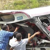 Rescuers reach for passengers from a bus that fell into a gorge in Jagtiyal district of Telangana, India, Tuesday. The bus carrying pilgrims from a Hindu temple in the hills of south India plunged off the road Tuesday, killing more than 50 people, including four children, officials said. Plunge of overcrowded bus carrying pilgrims in south India kills at least 55
