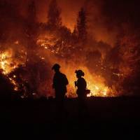 Firefighters monitor a backfire while battling the Ranch Fire, part of the Mendocino Complex Fire, near Ladoga, California, in August. While California officials quickly determined an arsonist started the wildfire burning southeast of Los Angeles and that sparks from a vehicle produced the deadly wildfire in the city of Redding, causes for many of the state’s worst blazes in the past decade remain a mystery. What ignited many of California's worst wildfires over past decade remains a mystery