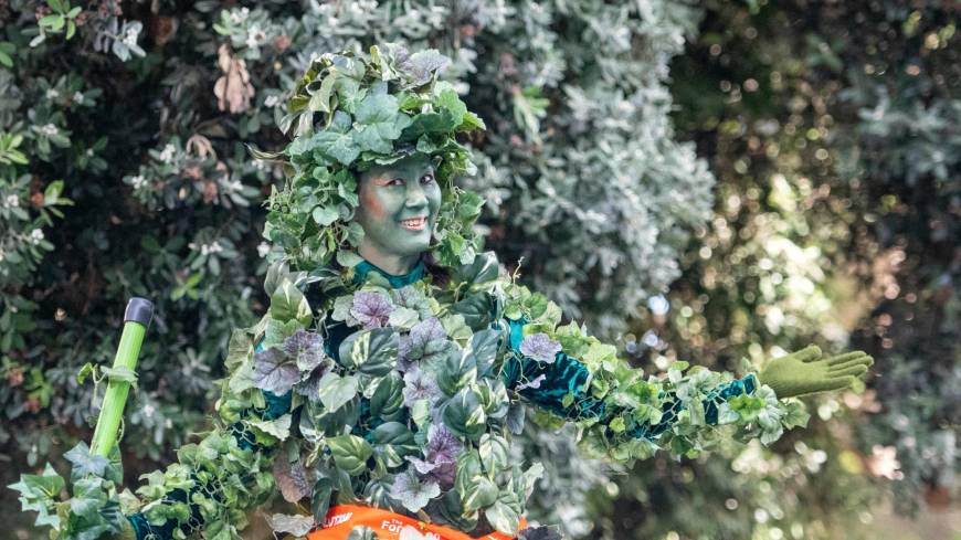 A woman dressed as a tree stands on a residential street during the Global Climate Action Summit in San Francisco on Friday. Optimism trumps despair at San Francisco climate summit