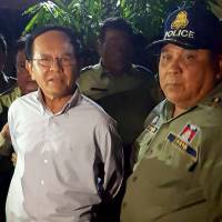 Cambodian opposition leader Kem Sokha is escorted by police at his home in Phnom Penh last September. Sokha was released from jail early Monday, a year after he was detained on treason charges, as the country’s strongman ruler loosens his grip on opponents after sweeping one-sided elections. Cambodian opposition leader Kem Sokha released from jail as Hun Sen eases crackdown on foes