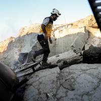 A member of the Syrian Civil Defense, also known as the “White Helmets,” walks through the wreckage of their center after it was destroyed by bombardment by government forces bombardment in the town of al-Tamana on the southern edges of the rebel-held Idlib province on Thursday. Syria is preparing chemical weapons for attacks in Idlib, U.S. envoy says