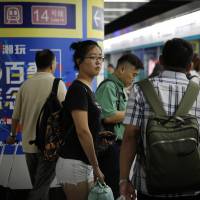 Ren Liping waits for a subway train as she prepares to file her petition with police headquarters after arriving at the south train station in Beijing on July 3. As #MeToo unnerves China, a student fights to tell her story