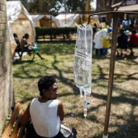 A cholera patient waits for treatment during an action organized by Zimbabwe’s health minister at the cholera treatment center of the Beatrice Infectious Diseases Hospital, in Harare, on Tuesday. WHO warns of rapid cholera spread in Harare as Zimbabwe death toll reaches 25