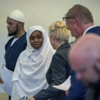 Siraj Ibn Wahhaj (left) and Jany Leveille talk with with attorneys on Aug. 29 in the Taos County Courthouse. Teen from squalid New Mexico compound was trained for jihad