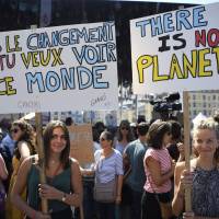 People hold banners on Saturday as they take part in a march on Saturday in Marseille, southern France, as part of a global day of action related to climate change. U.N. climate talks in Bangkok stumble over issues of financing