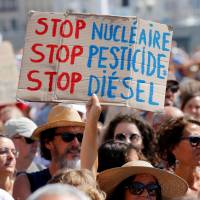 Environmental activists gather to urge world leaders to take action against climate change in Marseille, France, on Saturday. U.S. to miss Paris climate pact target by a third