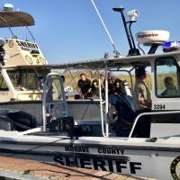 Mohave County Sheriff’s Office search and rescue boats look for four people missing on the Colorado River, north of Lake Havasu in Arizona Sunday. Four missing after boats collide and sink on Colorado River