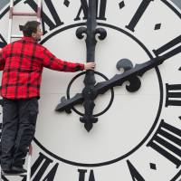 A technician works on the clock at the Lukaskirche Church in Dresden, Germany, in March. Seasonal clock changes: A controversial ritual