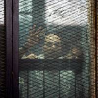 This picture shows detainees inside the soundproof glass dock of the courtroom during the trial of 700 defendants, including Egyptian photojournalist Mahmoud Abu Zeid, widely known as Shawkan, in Cairo on Saturday. An Egyptian court on Saturday handed a five-year jail sentence to prominent photojournalist Zeid, known as Shawkan, who earlier this year received UNESCO’s World Freedom Prize. Shawkan was one of more than 700 defendants on trial in the same case, most of them facing charges of killing police and vandalizing property during the clashes. Egypt sentences 75 to death, hundreds to jail over 2013 sit-in that ended in bloodshed