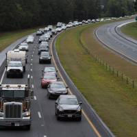 Residents evacuate from coastal areas near Wallace, North Carolina, on Tuesday. Hurricane Florence would deliver a “direct hit” to the U.S. East Coast, emergency officials warned, urging residents to heed evacuation orders and seek shelter from the potentially catastrophic storm. 'Big and vicious' Hurricane Florence bears down on Carolinas, threatens environmental onslaught