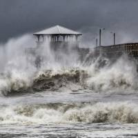 Waves slam the Oceana Pier & Pier House Restaurant in Atlantic Beach Thursday as Hurricane Florence approaches the Carolinas. 'Threat becomes reality' as Hurricane Florence lays drenching, blowing siege to Carolina coast