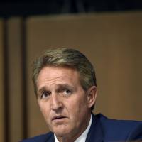Sen.Jeff Flake (R-AZ) listens during Brett Kavanaugh’s U.S. Senate Judiciary Committee confirmation hearing to be an Associate Justice on the U.S. Supreme Court, on Capitol Hill in Washington Tuesday. Republicans hit Trump for criticizing Justice Department after it charged GOP pair
