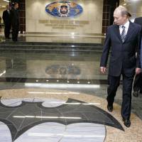Russian President Vladimir Putin walks through a hall in the building of the Main Directorate of the General Staff of the Armed Forces of Russia, also know as Russian military intelligence service in Moscow, Russia. The Russian military intelligence service GRU with a brutish reputation is increasingly taking on high-profile, high-risk operations to damage Russia’s enemies, or simply strike fear. Bumblers or just brazen assassins? Spotlight on Russia's ascendant GRU