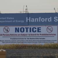 Signs are posted in 2017 by the Hanford Nuclear Reservation in Benton County in Richland, Washington. The U.S. government will pay $925,000 and improve worker safety to settle a lawsuit over employee exposure to chemical vapors at the nation’s most polluted nuclear weapons production site. Washington state Attorney General Bob Ferguson said Wednesday that the U.S. Energy Department will test new technology to capture and destroy dangerous vapors that escape from nuclear waste storage tanks at the Hanford Nuclear Reservation. U.S. agrees to boost worker safety at polluted Hanford nuke site, install vapor protections