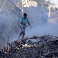 Syrians use dirt to put out a fire at the scene of a reported airstrike in the district of Jisr al-Shughur, in the Idlib province, on Tuesday. Russian warplanes battered Syria’s rebel-controlled northwestern Idlib province on Tuesday for the first time in three weeks, the Syrian Observatory for Human Rights reported, as fears of a government offensive mount. Syrian and Russian warplanes pound Idlib before talks on expected attack, killing 13 civilians: monitor