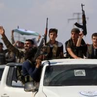 Syrian rebel fighters from the recently formed National Liberation Front parade following military training at an unknown location in the northern countryside of the Idlib province on Tuesday in anticipation for an upcoming government forces offensive. The Syrian regime and its Russian ally are threatening an offensive to retake the northwestern province of Idlib, Syria’s last rebel bastion. Syria regime assault on Idlib risks 'scattering terrorists' abroad: Paris