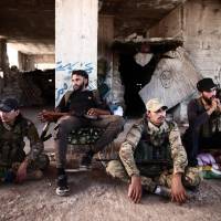 Fighters from the Nureddine al-Zinki unit, a moderate Syrian opposition faction affiliated with the Muslim Brotherhood and made up of former Syrian Free Army fighters, rest in a position in a rebel-held part of Aleppo province that lies directly east of the main opposition bastion in Idlib on Sunday. Under a Russia-Turkey agreement announced recently, a demilitarized zone is to be set up around Idlib, one of the country’s last major jihadi and rebel bastions on the border with Turkey. Two militant groups reject demilitarized zone set by Russia and Turkey in Syria's Idlib