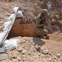 A Syrian rebel fighter emerges from a trench during the preparations in anticipation of an upcoming offensive by regime forces in the countryside of rebel-held northern Idlib province on Friday. Syrians on alert as decisive battle for Idlib looms
