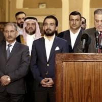 New Parliament Speaker Mohammed al-Halbousi (center), and his political bloc hold a news conference In Baghdad on Friday. Iraqis pick parliament speaker, opening way to new government four months after election