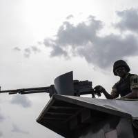 A member of the Nigerian Military Police sits on an armored vehicle during the African Land Forces Summit (ALFS) military demonstration held at General Ao Azazi barracks in Gwagwalada in April. At least 30 Nigerian soldiers died in combat with Boko Haram jihadists who overran a military base in the northeast near the border with Niger, two military sources told AFP on Saturday. Scores of jihadists in trucks stormed the base at Zari village in northern Borno state late Thursday and briefly seized it after a fierce battle, they said. Boko Haram splinter Islamists kill up to 30 soldiers in northeast Nigeria