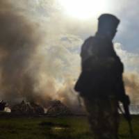 In this file photo taken in 2016 Kenya Wildlife Services (KWS) rangers stand guard around illegal stockpiles of burning elephant tusks, ivory figurines and rhinoceros horns at Nairobi National Park. DNA tests on smuggled elephant tusks have identified three major ivory cartels in Africa and are helping investigators bolster the criminal cases against some of the most dangerous traffickers, researchers said Wednesday. DNA sleuths bolster case against three key African ivory cartels