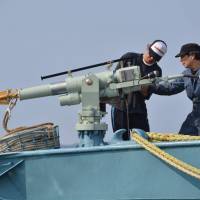 Crew members of a whaling ship check a whaling gun or harpoon before departure at Ayukawa port in Ishinomaki, Miyagi Prefecture, in 2014. IWC vote backs aboriginal whale hunts — with new quotas