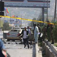 Afghan security personnel inspect a site following a suicide attack in Kabul on Sunday. A suicide bomber on a motorbike blew himself up near a convoy of gunmen commemorating the death anniversary of a famed resistance leader in Kabul , killing at least seven people, officials said. At least seven killed in suicide attack on Kabul commemorations