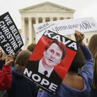 Protesters gather in front of the Supreme Court holding signs with the image of Judge Brett Kavanaugh that read “Kava Nope” and “We Believe Christine Blasey Ford” on Capitol Hill in Washington Monday. A second allegation of sexual misconduct has emerged against Kavanaugh, a development that has further imperiled his nomination to the Supreme Court, forced the White House and Senate Republicans onto the defensive and fueled calls from Democrats to postpone further action on his confirmation. President Donald Trump is so far standing by his nominee. As confirmation fight gets nastier, Republicans begin digging in on Kavanaugh