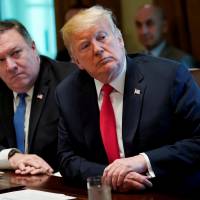 U.S. President Donald Trump and Secretary of State Mike Pompeo listen during a Cabinet meeting at the White House in Washington on Aug. 16. Trump, Pompeo bash former Secretary of State John Kerry for meeting with Iran minister