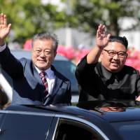 South Korean President Moon Jae-in and North Korean leader Kim Jong Un wave during a car parade in Pyongyang on Tuesday. A Kim Jong Un visit to Seoul? It would be surreal challenge