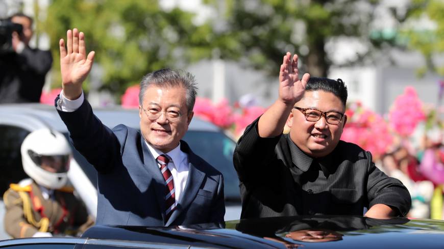 South Korean President Moon Jae-in and North Korean leader Kim Jong Un wave during a car parade in Pyongyang on Tuesday. A Kim Jong Un visit to Seoul? It would be surreal challenge