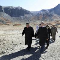 North Korean leader Kim Jong Un (left) and South Korean President Moon Jae-in visit Mount Paektu, in North Korea, Thursday. A beaming South Korean President Moon, freshly returned home Thursday from a whirlwind three-day summit with Kim Jong Un, said the North Korean leader wants the U.S. secretary of state to visit Pyongyang soon for nuclear talks, and also hopes for a quick follow-up to his June summit with President Donald Trump. Kim wants another Trump summit to speed North Korea's denuclearization and declare end to war: Moon