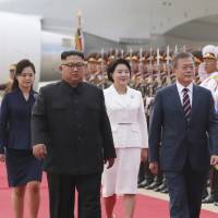 North Korean leader Kim Jong Un, South Korean President Moon Jae-in and their wives inspect an honor guard during a welcoming ceremony at Sunan International Airport in Pyongyang on Tuesday. A look at the Koreas' push for formal end to Korean War