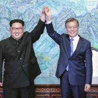 North Korean leader Kim Jong Un and South Korean President Moon Jae-in raise their hands after signing a joint statement at the border village of Panmunjom in the Demilitarized Zone on April 27. Skepticism grows in South Korea ahead of third summit with North