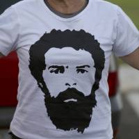 A supporter of former Brazilian President Luiz Inacio Lula da Silva sports a T-shirt with his image during a protest in Brasilia on Friday. Brazil bars jailed ex-president da Silva from running in October