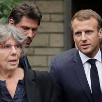 French President Emmanuel Macron walks next to Michele Audin, daughter of the late Maurice Audin, as he leaves the home of Josette Audin, widow of Audin, on Thursday in Bagnolet, France. Macron acknowledged that mathematician Maurice Audin, a communist pro-independence activist who disappeared in 1957, “died under torture stemming from the system instigated while Algeria was part of France,” his office said. Macron admits France had system of torture during Algeria war, asks widow for pardon