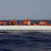 An Open Arms lifeguard gives a thumbs-up to a migrant at the other end of a rubber boat in the middle of a rescue operation some 30 nautical miles off the coast of Libya in the Mediterranean Sea June 30. The U.N. refugee agency says people smugglers are taking greater risks to ferry their human cargo toward Europe as Libya’s coast guard increasingly intercepts boats carrying migrants, increasing the likelihood that those on board may die on the Mediterranean journey. That’s one of the key findings from the latest UNHCR report about efforts to reach Europe. Mediterranean crossings 'deadlier than ever': U.N.