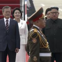 In this video still South Korean President Moon Jae-in and his wife Kim Jung-sook (second from left), stand with North Korean leader Kim Jong Un and his wife Ri Sol Ju upon their arrival in Pyongyang on Tuesday. Moon landing: South Korean leader begins three-day summit with North's Kim Jong Un