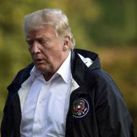 President Donald Trump walks across the South Lawn of the White House in Washington Wednesda after returning from a trip to survey the damage from Hurricane Florence in North Carolina and South Carolina. Robert Mueller's legal actions not overlooked by Trump