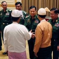 Myanmar’s military chief, Min Aung Hlaing (right), meets newly appointed Myanmar President Win Myint (third from right) at the parliament in Naypyidaw on March 30. Myanmar army should be removed from politics: U.N.