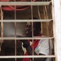 Juju priest David Ubebe performs a ceremony in his shrine in Benin City, Nigeria, on July 1. Black magic traps Nigerians in sex slavery abroad
