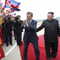 South Korean President Moon Jae-in is greeted by North Koreans as North Korean leader Kim Jong Un looks on during a welcoming ceremony at Sunan International Airport in Pyongyang on Sept. 18. Could appealing to Trump's ego be key to solving the North Korean nuclear crisis? Moon and Kim think so.