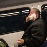 A screenshot from Twitter user @pbenti007’s video. Careless whiskers: New Jersey commuter shaves on train