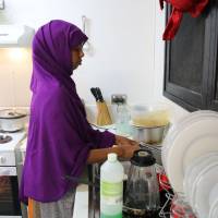 A refugee from Somalia does kitchen chores at refugee camp No. 5 on the Pacific island of Nauru on Sept. 2. A rare look behind the wire in Australia's 'Pacific Gulag' on Nauru