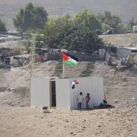 Palestinian girls sit by newly made shed in the West Bank Bedouin community of Khan al-Ahmar Tuesday. Israel says Khan al-Ahmar was illegally built and has offered to resettle residents 12 km (7 miles) away. Critics say its removal is meant to make room for an Israeli settlement. Israel’s Supreme Court rejected an appeal last week, paving the way for demolition. Palestinians file war crimes claim against Israel at ICC over West Bank Bedouin hamlet