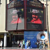 A picture of Burt Reynolds is seen on the TLC Chinese Theatre on the Hollyod walk of fame in Hollywood, California, Thursday. U.S. actor Burt Reynolds, best known for his roles in “Deliverance” and “Boogie Nights,” died, his publicist announced. The 82-year-old actor, who was a huge box office attraction in the 1970s, died at a hospital in Florida, his manager, Erik Kritzer, told the Hollywood Reporter. Burt Reynolds, star of film, TV and tabloids, dead at 82